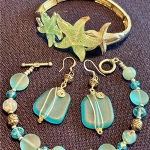 Artisan made blue sea glass earrings with contrasting silver tone wire design